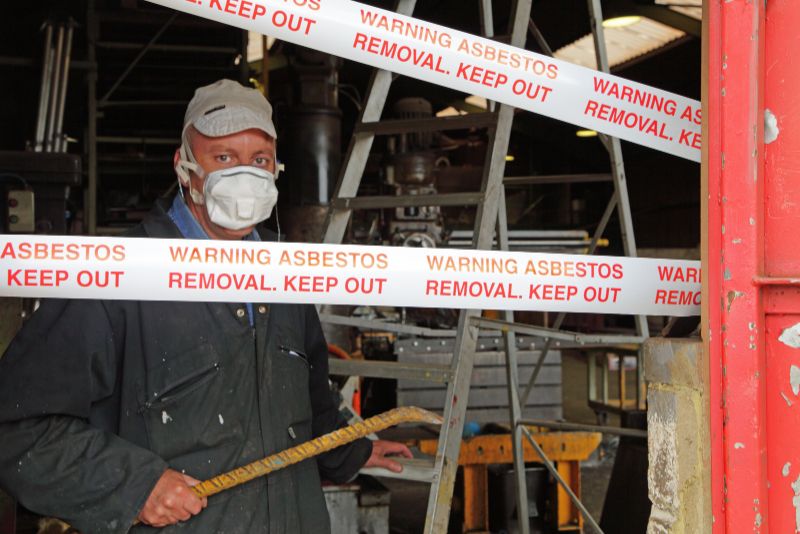a man removing asbestos from a demolition